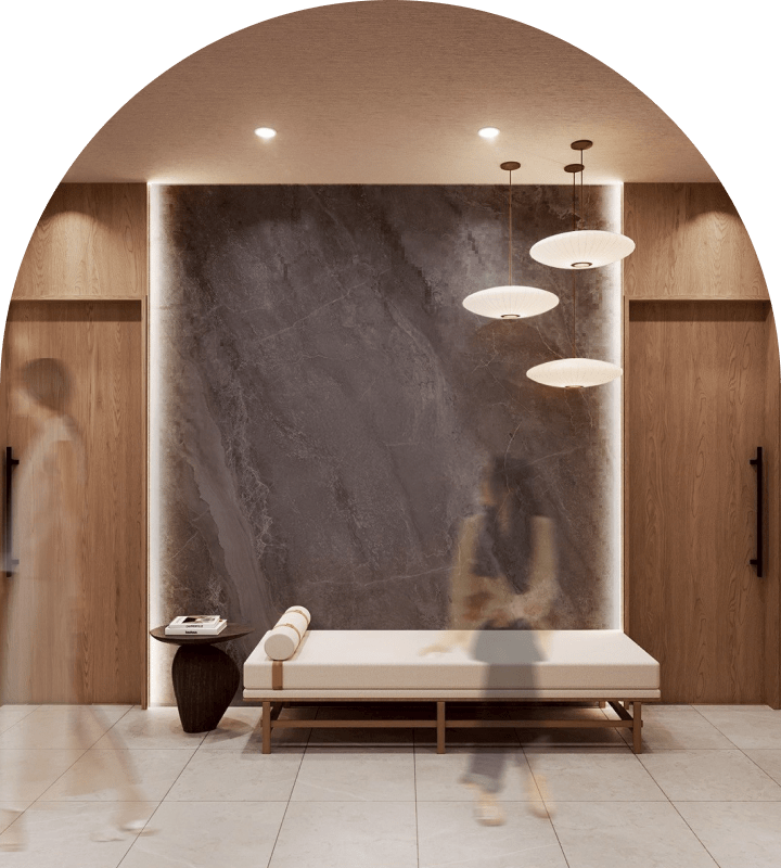 BE ONE CLINIC の待合ラウンジ。大判石材の壁面とソファが配置された上質な内観